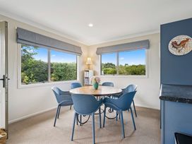 A dining room with a table and chairs at Martinborough Holiday Home, Martinborough