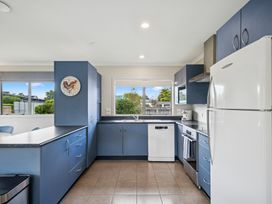 A kitchen with appliances and countertop at Martinborough Holiday Home Martinborough