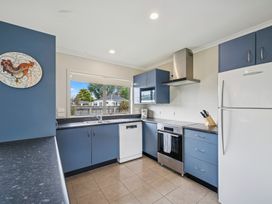 A kitchen with appliances and a window at Martinborough Holiday Home in Martinborough