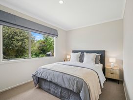 A bedroom with a bed and window at Martinborough Holiday Home in Martinborough