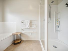 A bathroom with a shower and bathtub at Martinborough Holiday Home in Martinborough