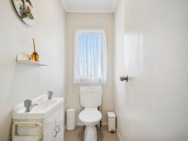 A bathroom with a toilet and sink at Martinborough Holiday Home in Martinborough