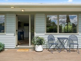 A door with a table and chairs outside at Martinborough Holiday Home Martinborough
