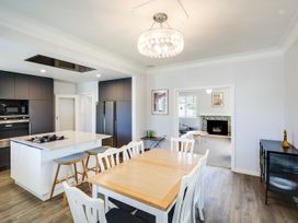 A kitchen with a dining table and chairs at Deco-licious - Napier Holiday Home, Napier