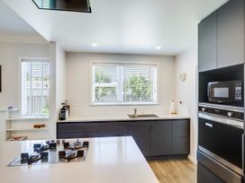 A kitchen with modern appliances and a window at Deco-licious - Napier Holiday Home Napier
