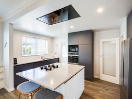 A kitchen with a stove and refrigerator at Deco-licious - Napier Holiday Home in Napier