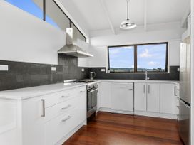 A kitchen with stove and sink at Mania Views Waipu