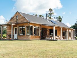 A house with a patio and garden at Mangawhai Heads