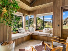 A snug with a seating area and windows at Mangawhai Heads
