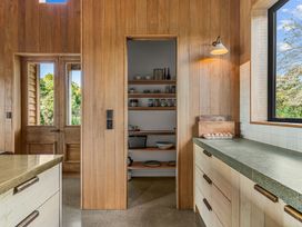 A kitchen with a shelf and countertop at Mangawhai Heads