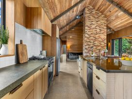 A kitchen with countertop appliances and cabinetry at Mangawhai Heads