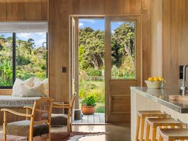 A living room with a view of the outdoors at Mangawhai Heads