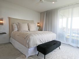 A bedroom with a bed and a bedside table at New Plymouth Holiday Home, New Plymouth