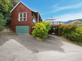 A house with a garage and deck at Harbour Heights - Akaroa Holiday Home Akaroa