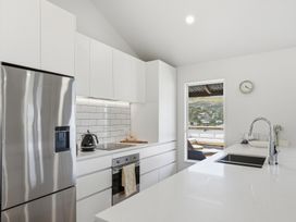 A kitchen with a stove and refrigerator at Harbour Heights - Akaroa Holiday Home in Akaroa