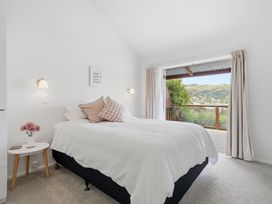 A bedroom with a bed and nightstand at Harbour Heights - Akaroa Holiday Home Akaroa