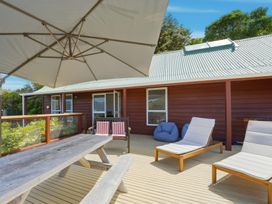 An outdoor seating area with a table and chairs at Harbour Heights - Akaroa Holiday Home