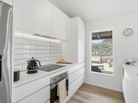 A kitchen with a stove and kettle at Harbour Heights - Akaroa Holiday Home Akaroa