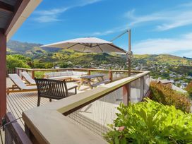 An outdoor space with seating and a table at Harbour Heights - Akaroa Holiday Home in Akaroa