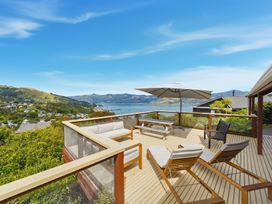 A deck with outdoor furniture and a view at Harbour Heights - Akaroa Holiday Home in Akaroa