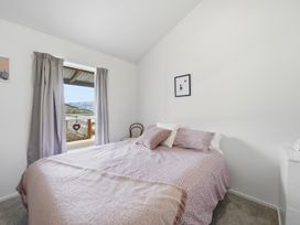 A bedroom with a bed and window view at Harbour Heights - Akaroa Holiday Home Akaroa