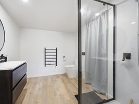 A bathroom with a shower and sink at Harbour Heights - Akaroa Holiday Home in Akaroa
