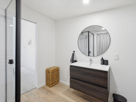 A bathroom with a sink and mirror at Harbour Heights - Akaroa Holiday Home, Akaroa
