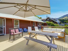 An outdoor area with seating and a table at Harbour Heights - Akaroa Holiday Home in Akaroa