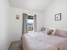 A bedroom with a bed and window view at Harbour Heights - Akaroa Holiday Home in Akaroa