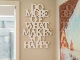 A wall art display with a quote at Petit Paradis - Whitianga Holiday Home in Whitianga