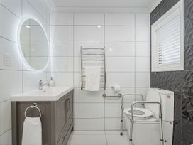 A bathroom with a sink and toilet at Petit Paradis - Whitianga Holiday Home Whitianga