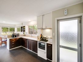 A kitchen with appliances and a window at Napier Holiday Home in Napier
