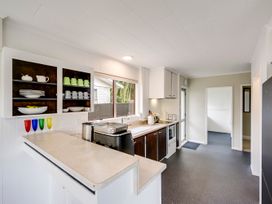A kitchen with cabinets and countertop at Napier Holiday Home in Napier