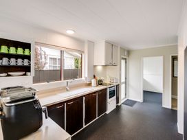 A kitchen with cabinets and appliances at Napier Holiday Home in Napier