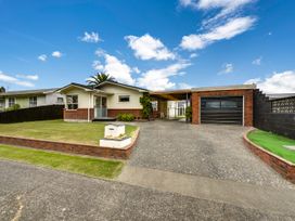 A house with a driveway and garage at Napier Holiday Home in Napier