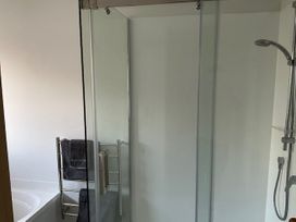 A bathroom with a shower and towel rail at The Orewa Beach House - 200 Steps to Orewa Beach, Orewa