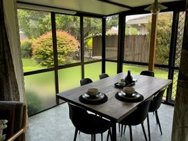 A dining room with a table and chairs at The Orewa Beach House - 200 Steps to Orewa Beach, Orewa