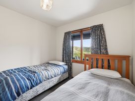A bedroom with two beds and a window at JD'S Place - Akaroa Holiday Home Akaroa