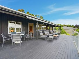 A deck with seating and a table at JD'S Place - Akaroa Holiday Home Akaroa