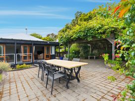An outdoor patio with a table and chairs at JD'S Place - Akaroa Holiday Home, Akaroa