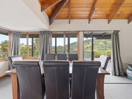 A dining room with a wooden table and chairs at JD'S Place - Akaroa Holiday Home Akaroa
