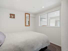 A bedroom with a bed and window at JD'S Place - Akaroa Holiday Home in Akaroa