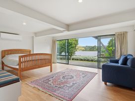 A bedroom with a bed and a view at JD'S Place - Akaroa Holiday Home Akaroa