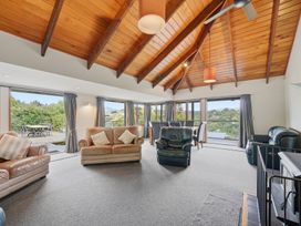 A living room with sofas and a dining table at JD'S Place - Akaroa Holiday Home, Akaroa