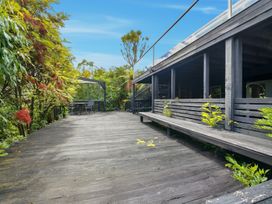 An outdoor area with a deck, table, and chairs at JD'S Place - Akaroa Holiday Home Akaroa