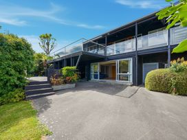 A house with a deck and garden at JD'S Place - Akaroa Holiday Home, Akaroa