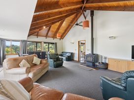A living room with sofa and fireplace at JD'S Place - Akaroa Holiday Home in Akaroa