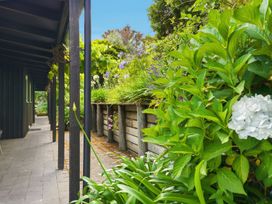 An outdoor area with a pathway and flowers at JD'S Place - Akaroa Holiday Home Akaroa