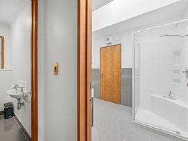 A bathroom with a sink and shower at JD'S Place - Akaroa Holiday Home