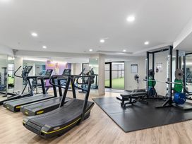 A gym with treadmills and a weight bench at a fitness center in Auckland